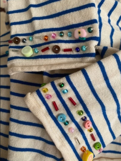 Beads and buttons on sweater sleeves